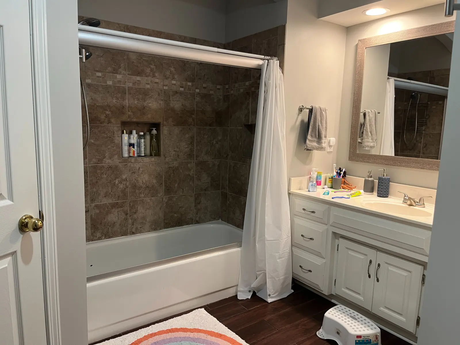 Primary bathroom with corner soaker tub and twin vanities — before