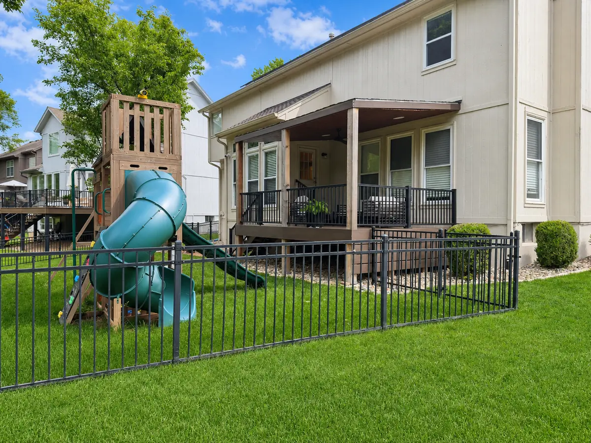 Backyard with playset and covered deck — after
