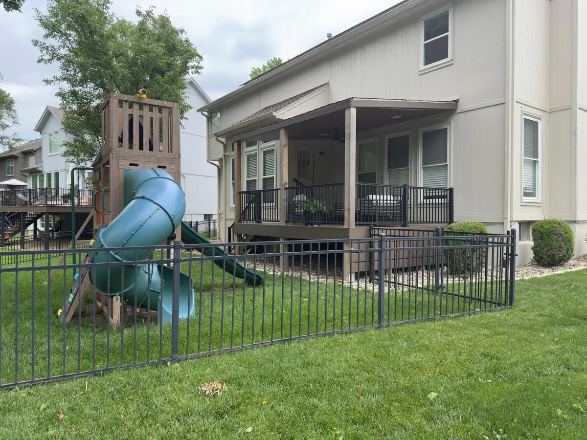 Backyard with playset and covered deck — before