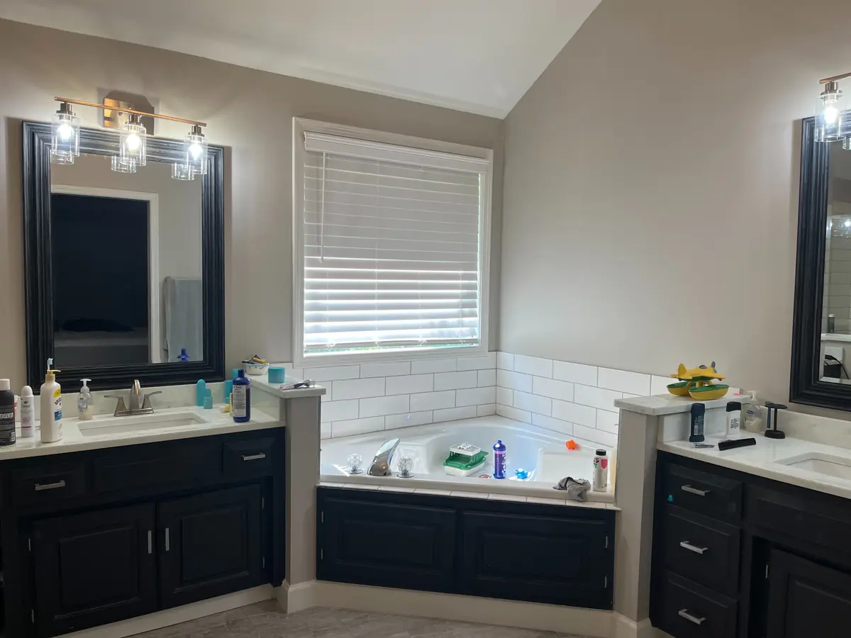 Small toilet room with framed art — before