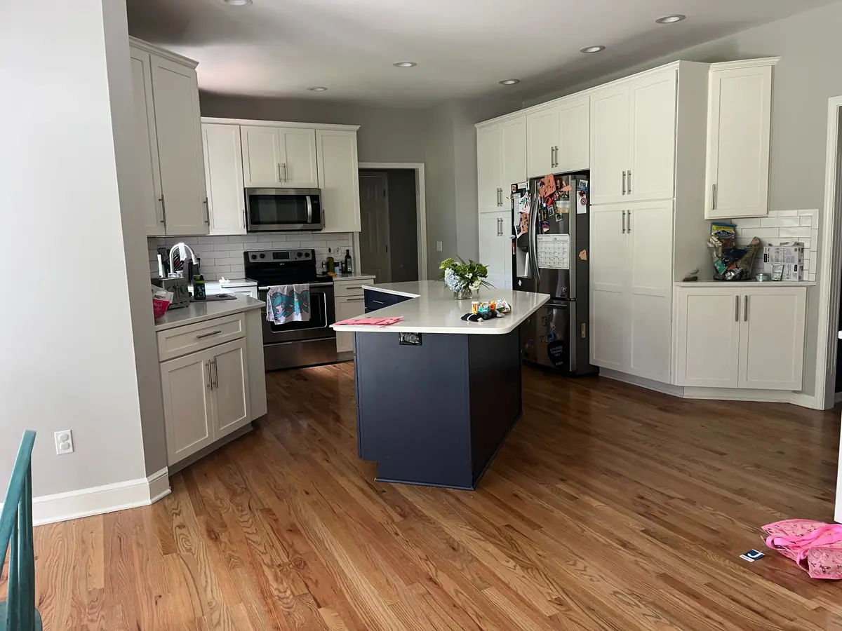 Open-concept kitchen with navy island — before